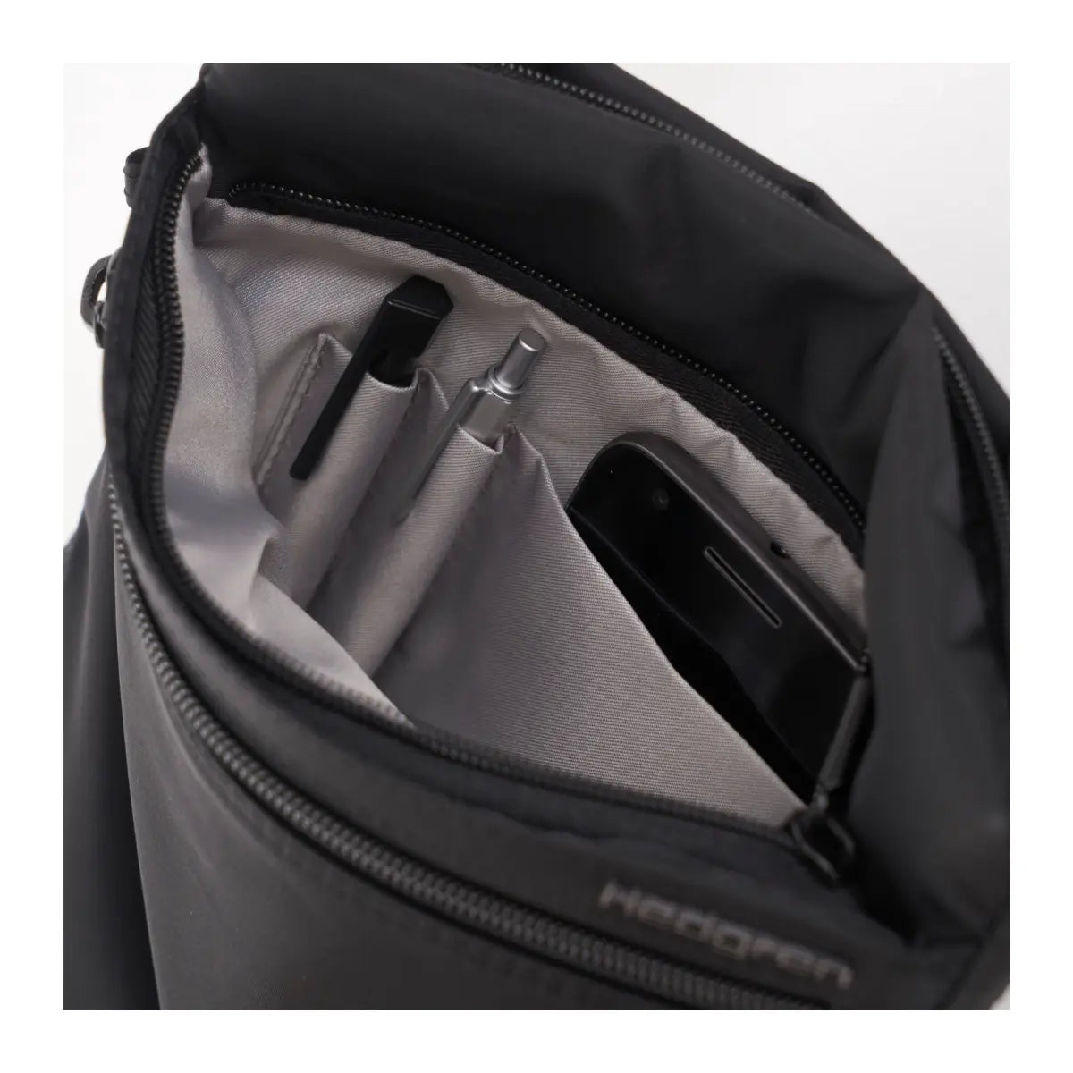 Hidden zippered compartment has pen loops and one open slip pocket