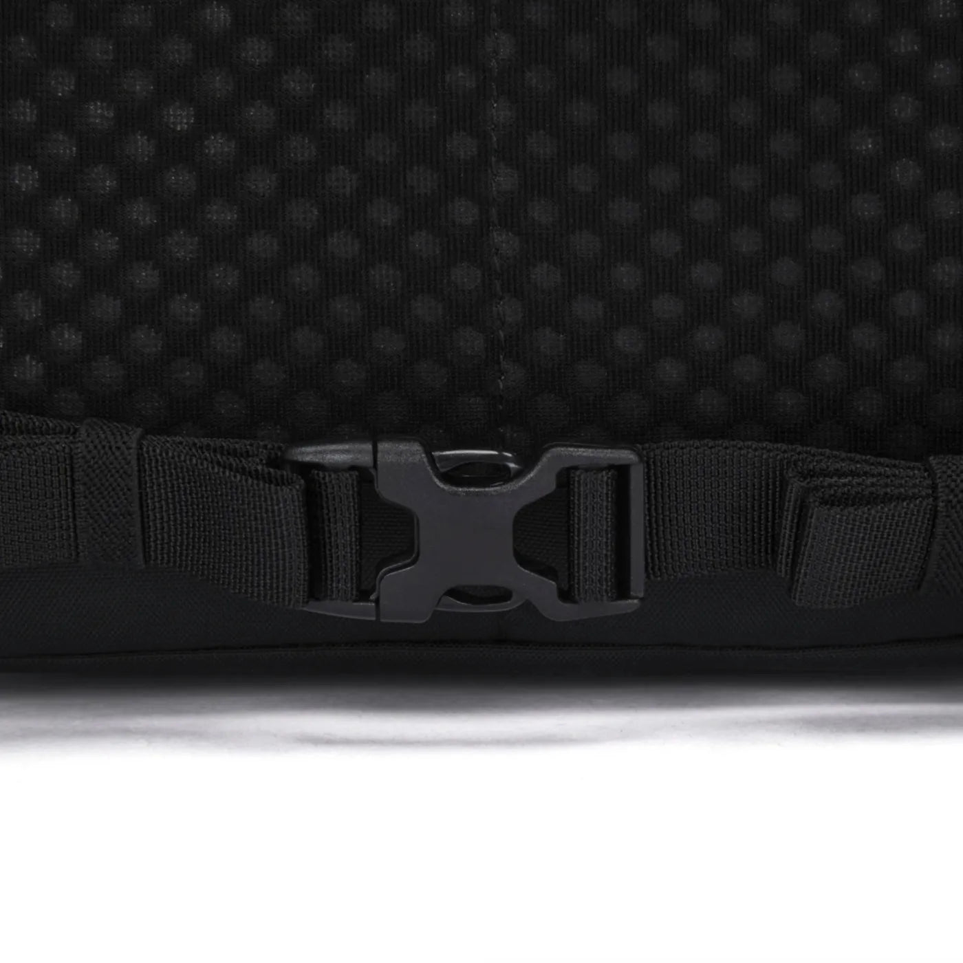 Black plastic buckle on a black textured strap of the pacsafe v city 20l laptop backpack for quick access security