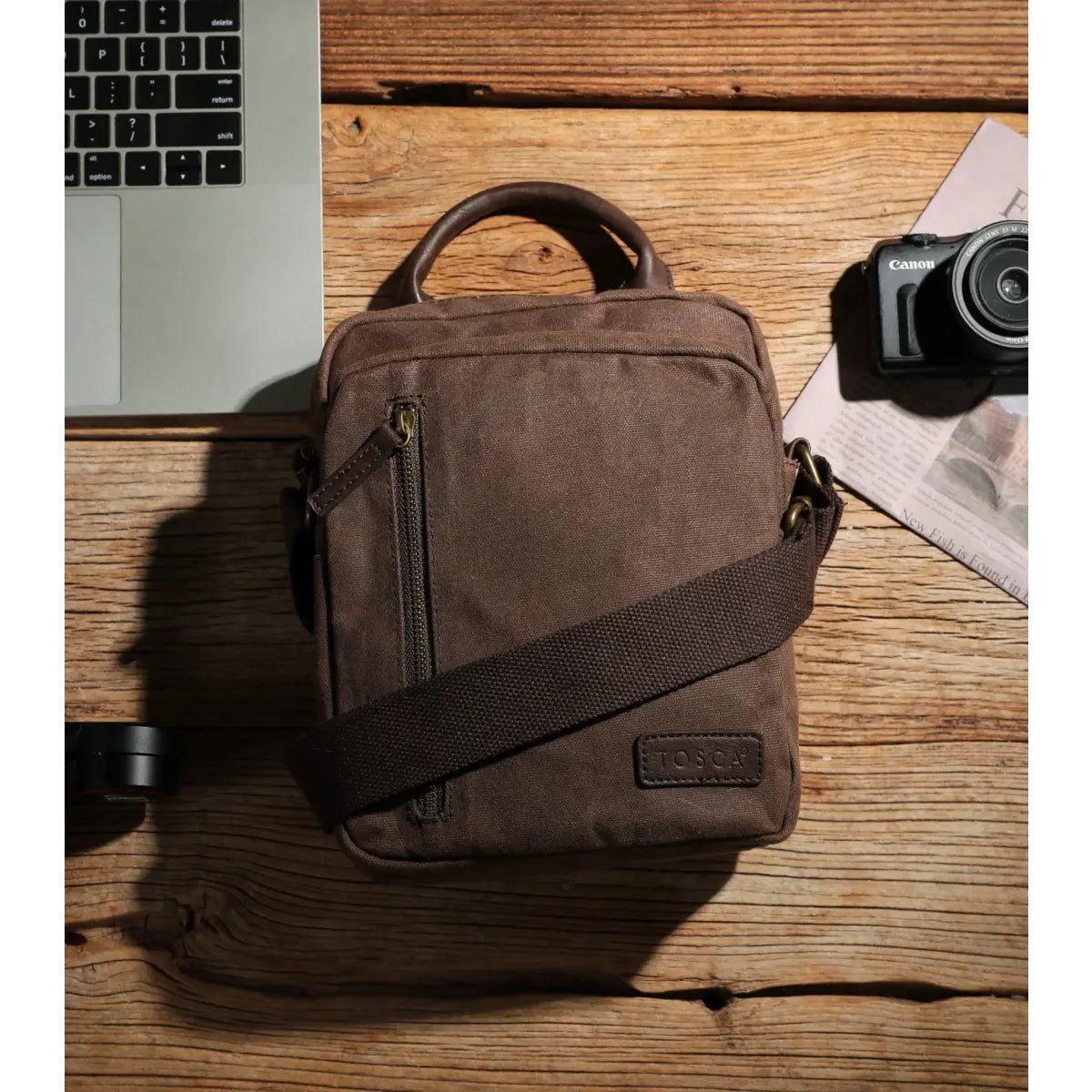 Made from waxed canvas, the crossbody bag comes with an adjustable strap