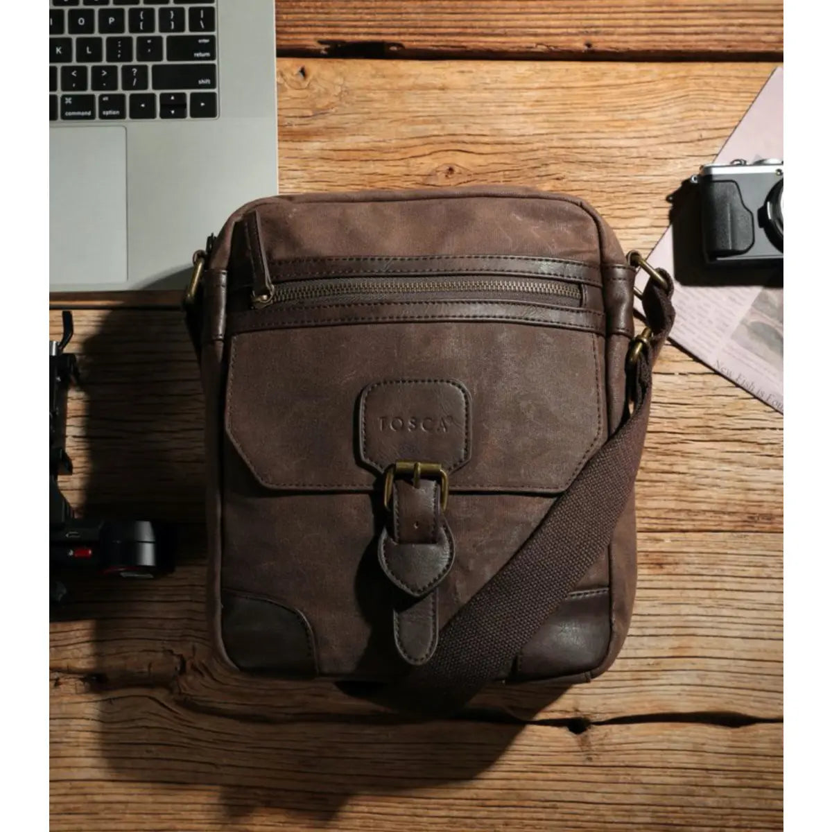 Made from waxed canvas, the cross body bag comes with an adjustable strap