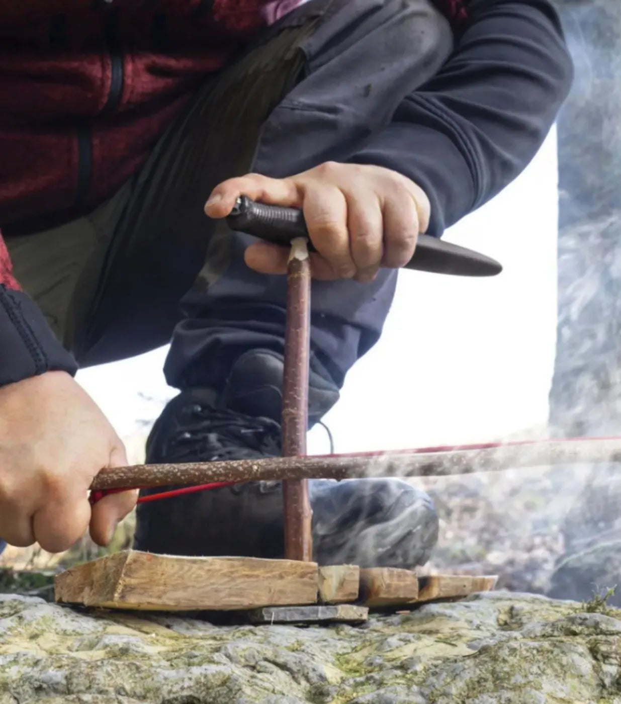 integrated bow drill divot turns the knife into a pressure piece to help ignite a fire