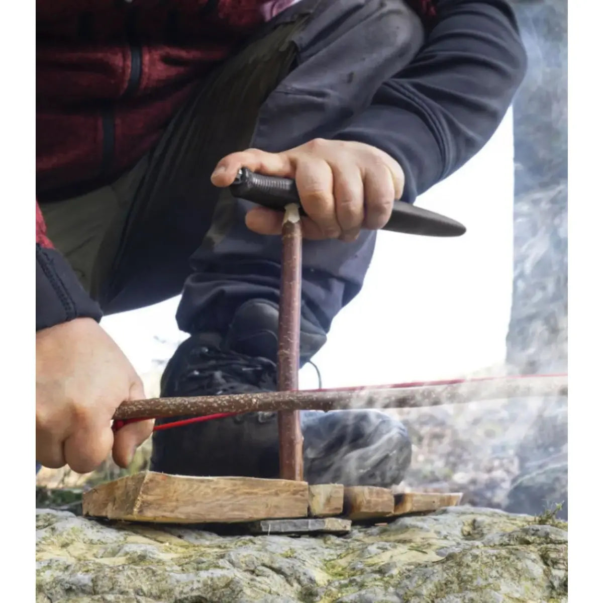 integrated bow drill divot turns the knife into a pressure piece to help ignite a fire