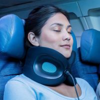 Lady on airplane with a Cabeau Evolution X travel neck pillow
