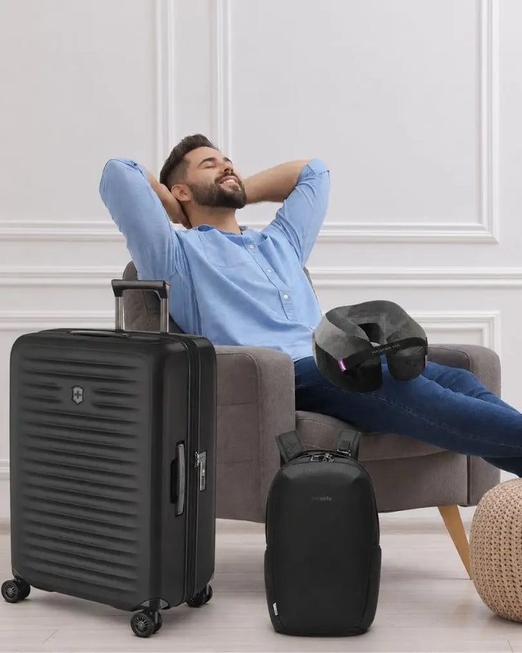Father’s Day Gift Ideas Australia 2026 - man happy with his new Victorinox Airox Suitcase, Pacsafe Backpack and Cabeau Evolution TNE pillow