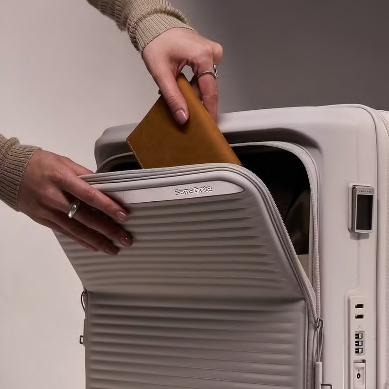 Hand sliding a tablet into the Samsonite Paralux front pocket
