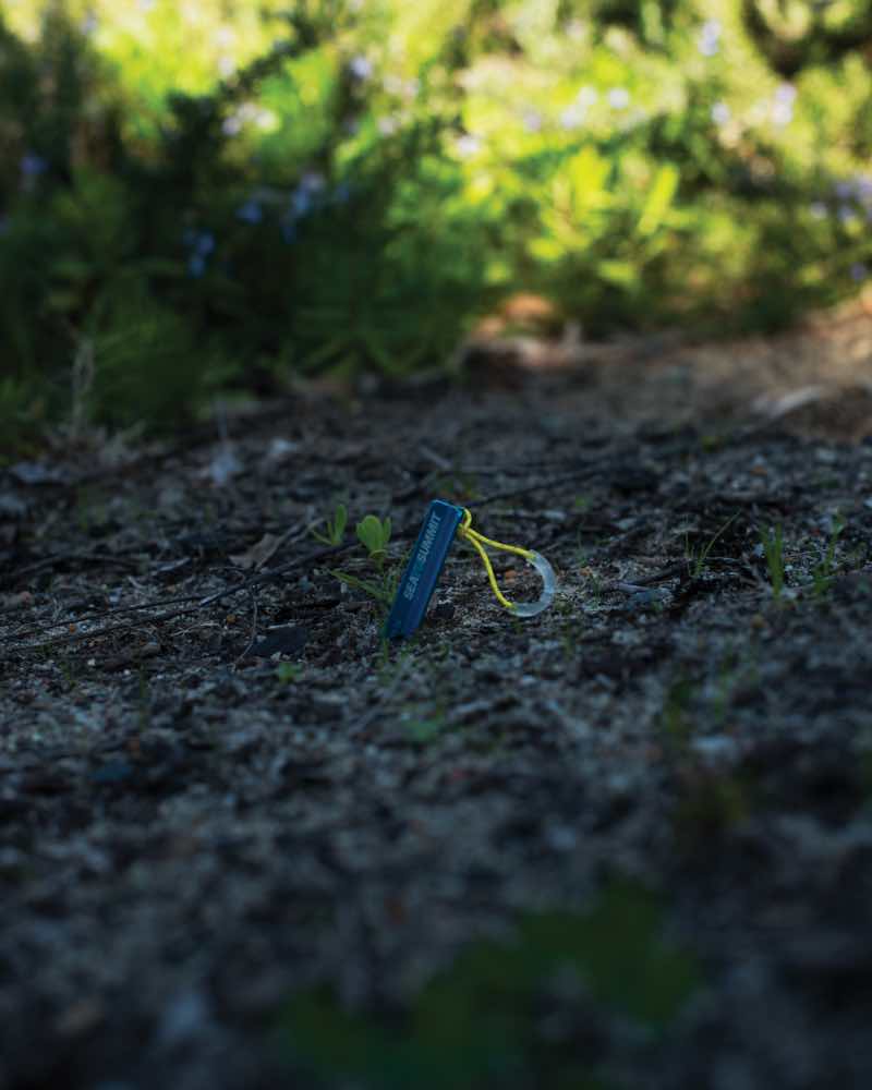 Luminescent pull loop for peg extraction; charges in sunlight, emits green glow at night