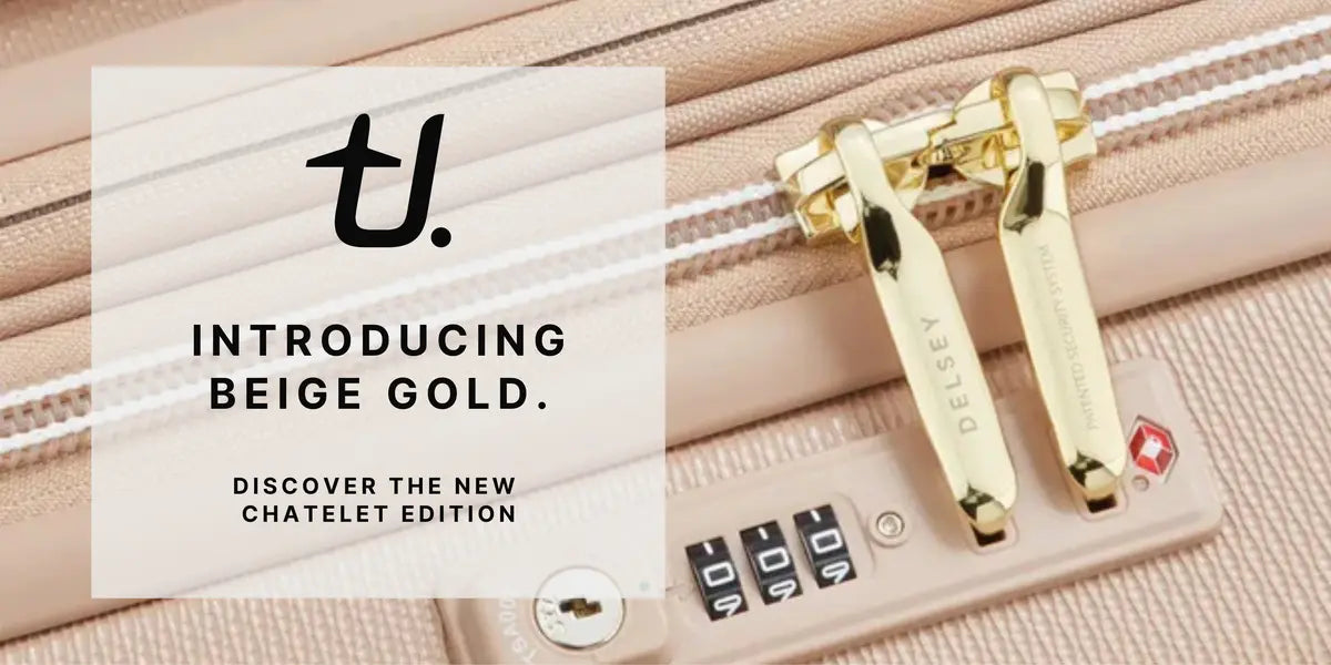 NEW Beige Delsey Chatelet suitcase with gold lock and text introducing 'Beige Gold' Chatelet edition.