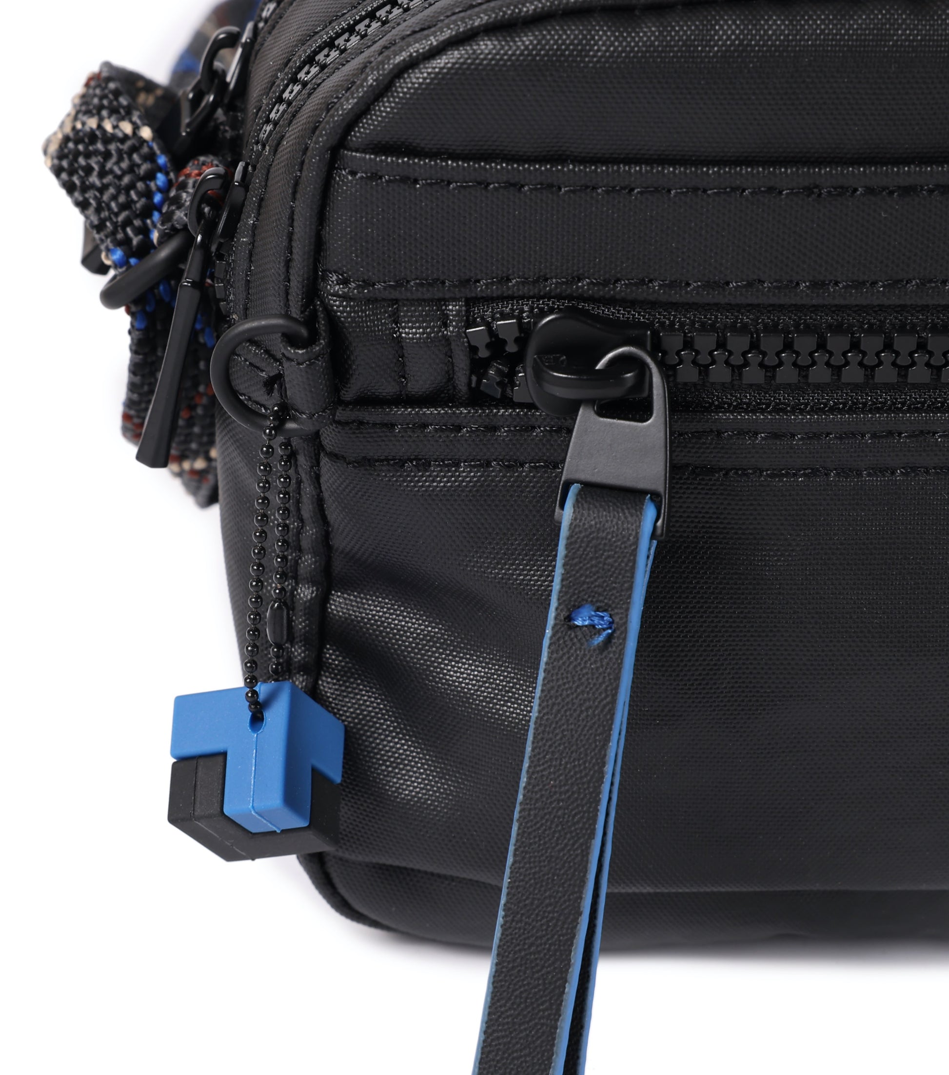 adorned with a cube hanger, moulded zipper tapes and a soft-touch front puller