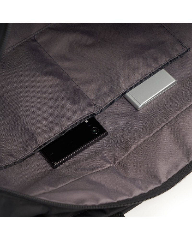 Zippered main compartment has two open slip pockets