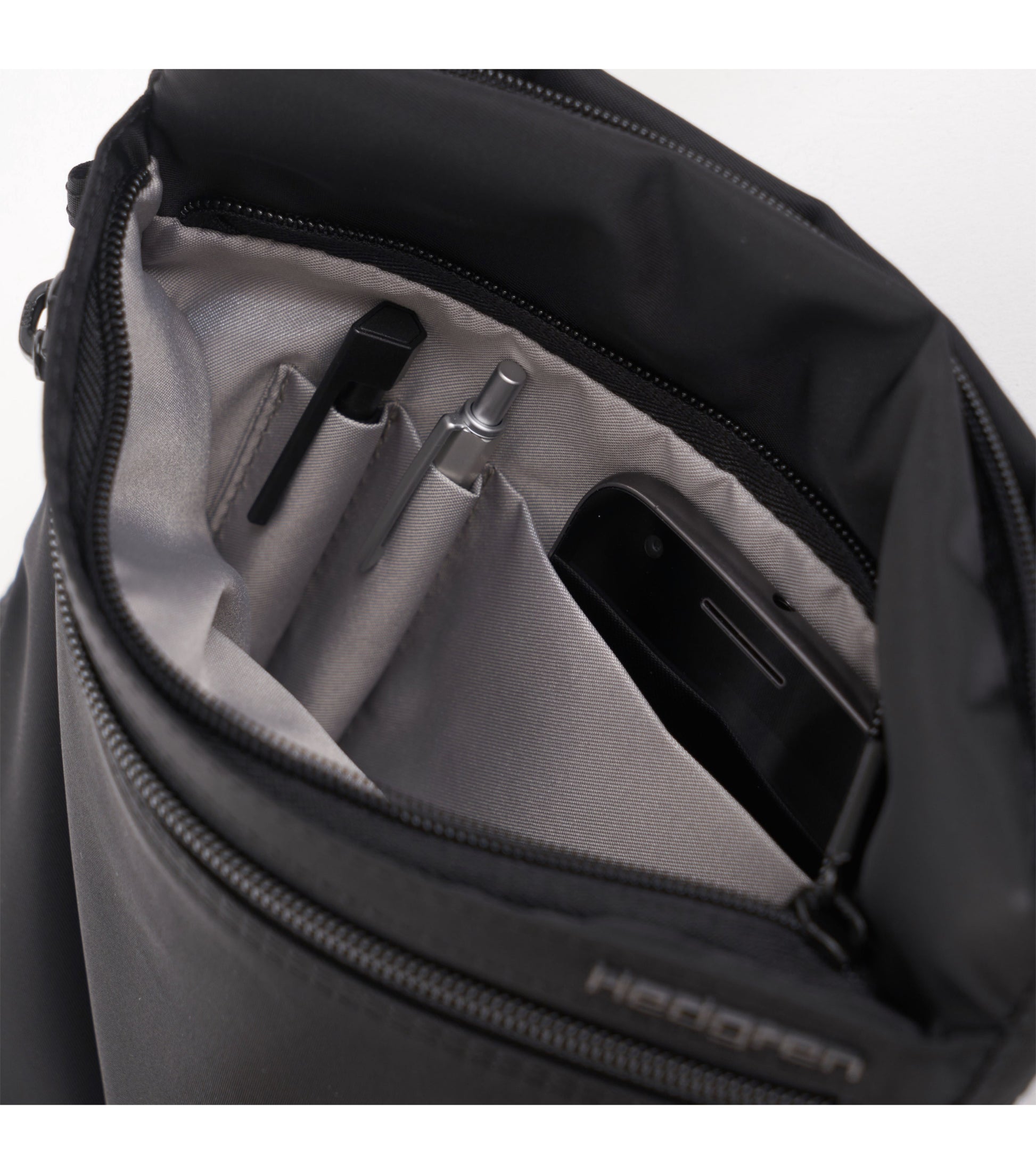 Hidden zippered compartment has pen loops and one open slip pocket