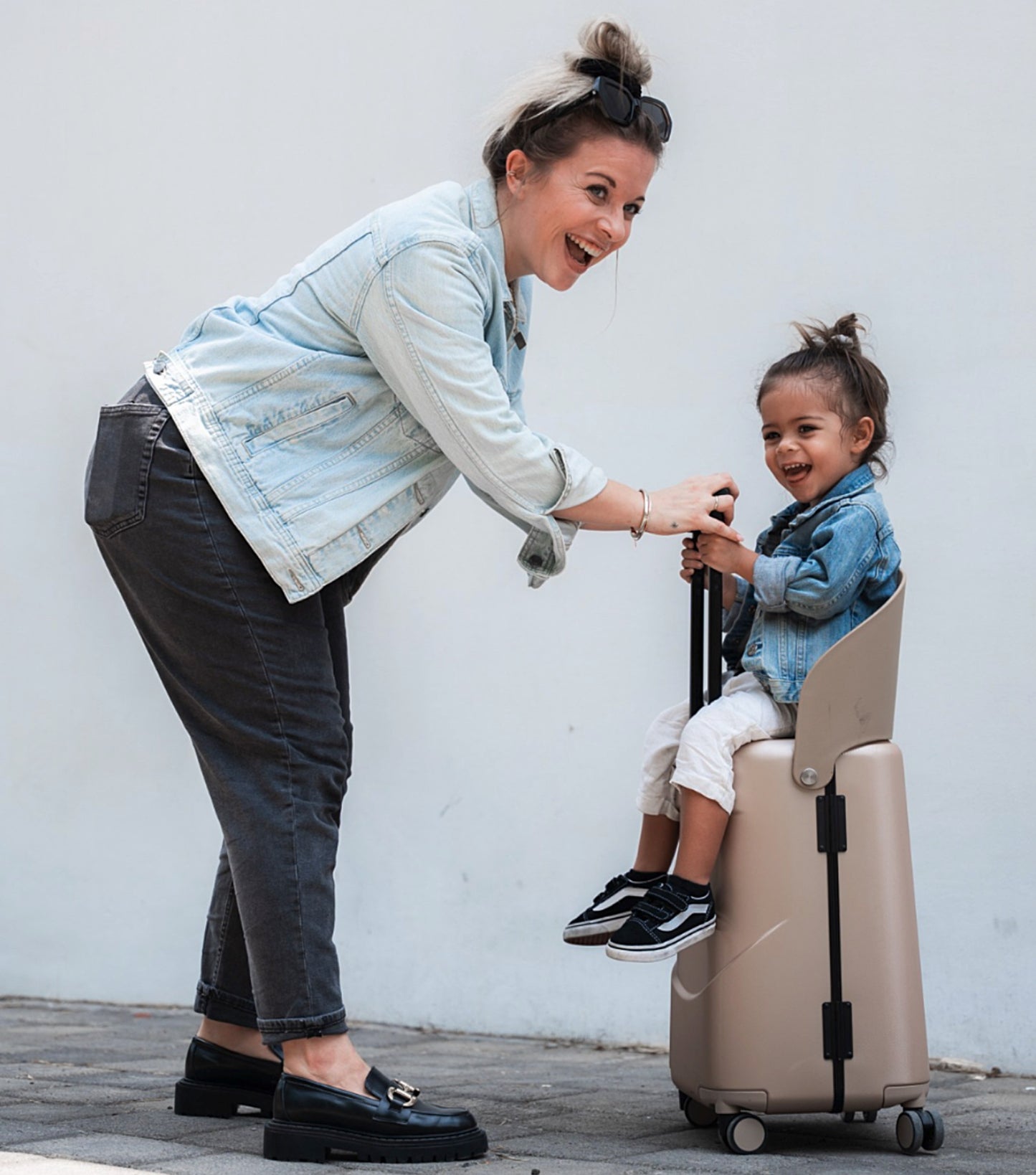 the MiaMily luggage bag universally configures into a ride on suitcase for children