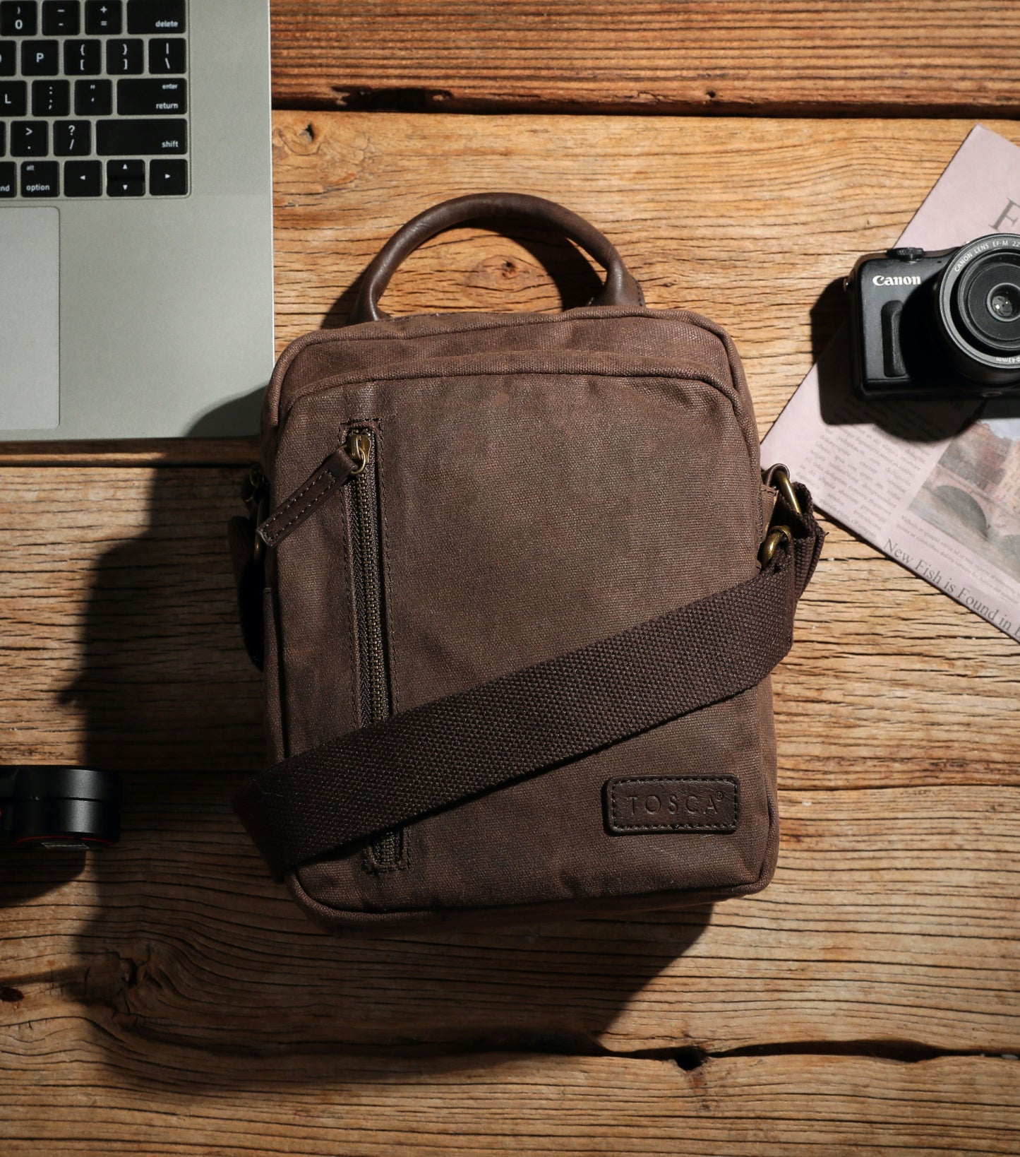 Made from waxed canvas, the crossbody bag comes with an adjustable strap