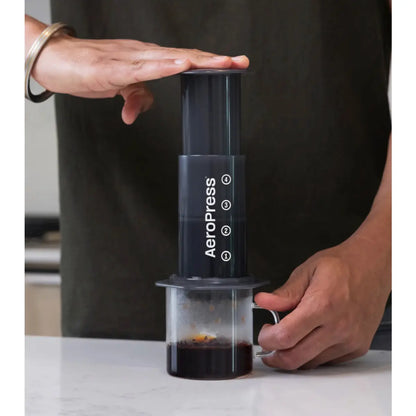 Air pressure quickly pushes the brew through the coffee bed and filter