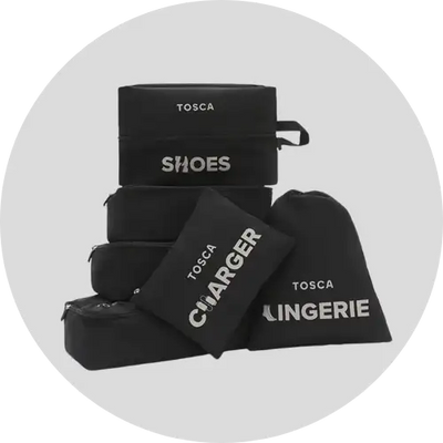 Black fabric travel organizer set with white embroidered labels for shoes, charger, and lingerie.