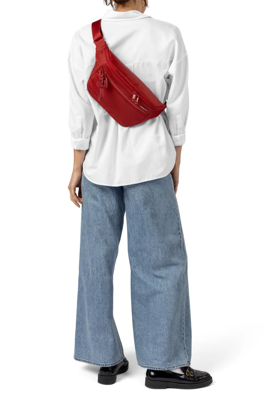 Hedgren BRANCO NEO Sling Crossbody with RFID in Black, worn across the back over a white shirt, seen from behind
