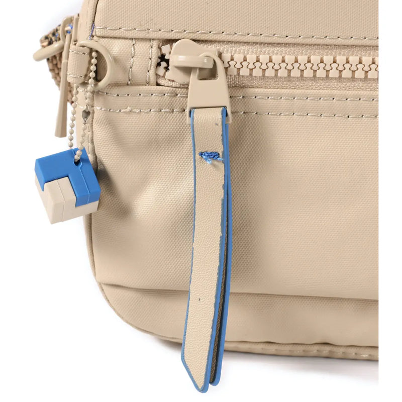 Adorned with a decorative cube and tone-on-tone hardware