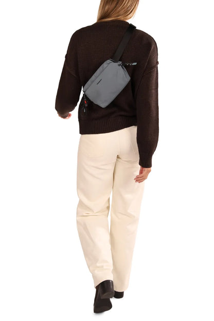 Hedgren JUN Waistbag in Vulcan Blue, worn across the back over a brown knit, seen from behind