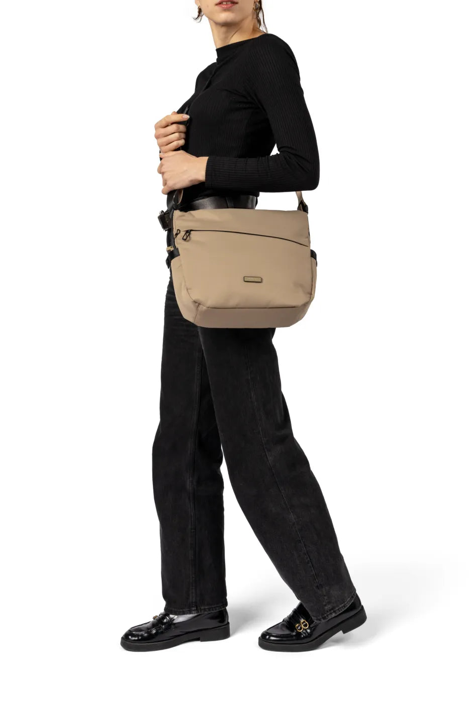 Hedgren MILKY WAY Large Crossover Shoulder Bag in Green Milieu, worn crossbody at the hip by a woman in a black top, seen from the side