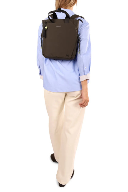Hedgren NORIO Small Backpack in Black, worn on both shoulders over a blue shirt, seen from behind