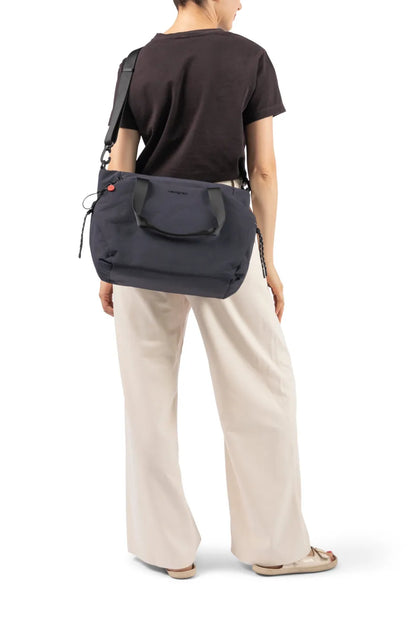 Hedgren SATOSHI 14" Laptop Tote in Duck Green, carried on the shoulder by a woman in a brown tee, seen from behind