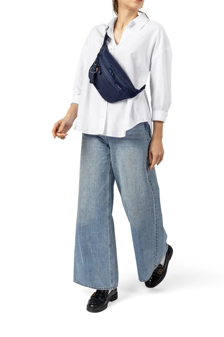 Hedgren ZIVA NEO  Waistbag with RFID in Print SS26, worn across the chest by a woman in a white shirt and wide jeans
