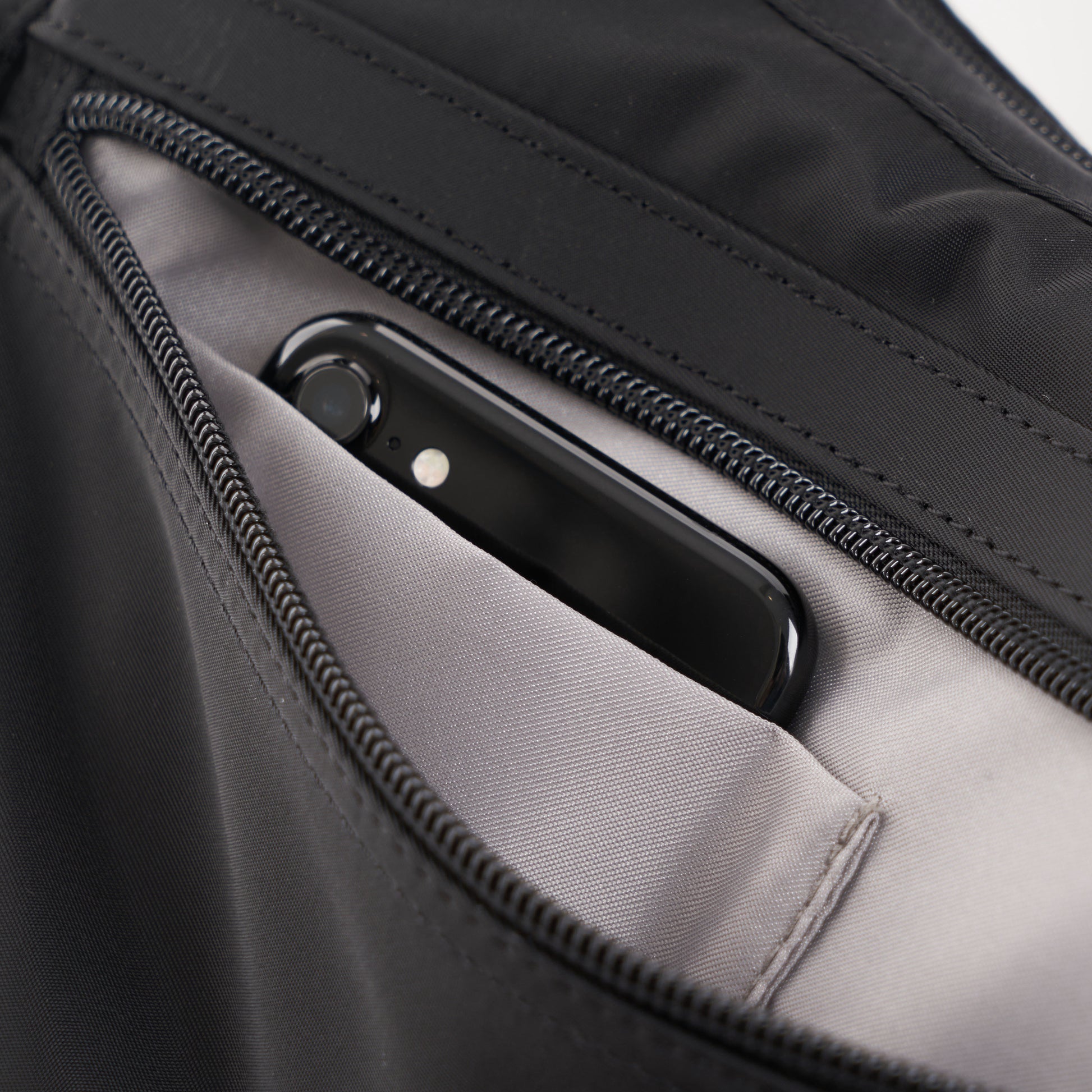 Front zippered compartment has one open slip pocket