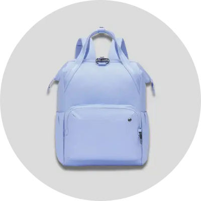 Light blue nylon backpack with dual top handles and a front zippered pocket.