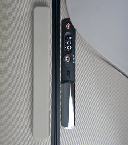 Black and silver digital lock door handle on the mist grey miaMily 48 cm ride-on carry on luggage with portable seat
