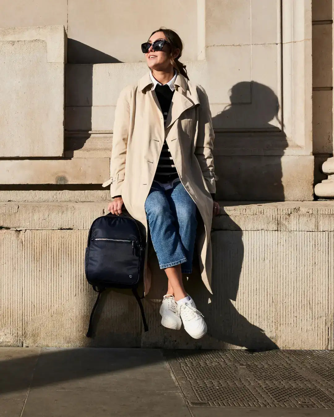Navy blue backpack with black straps and a front zipper pocket