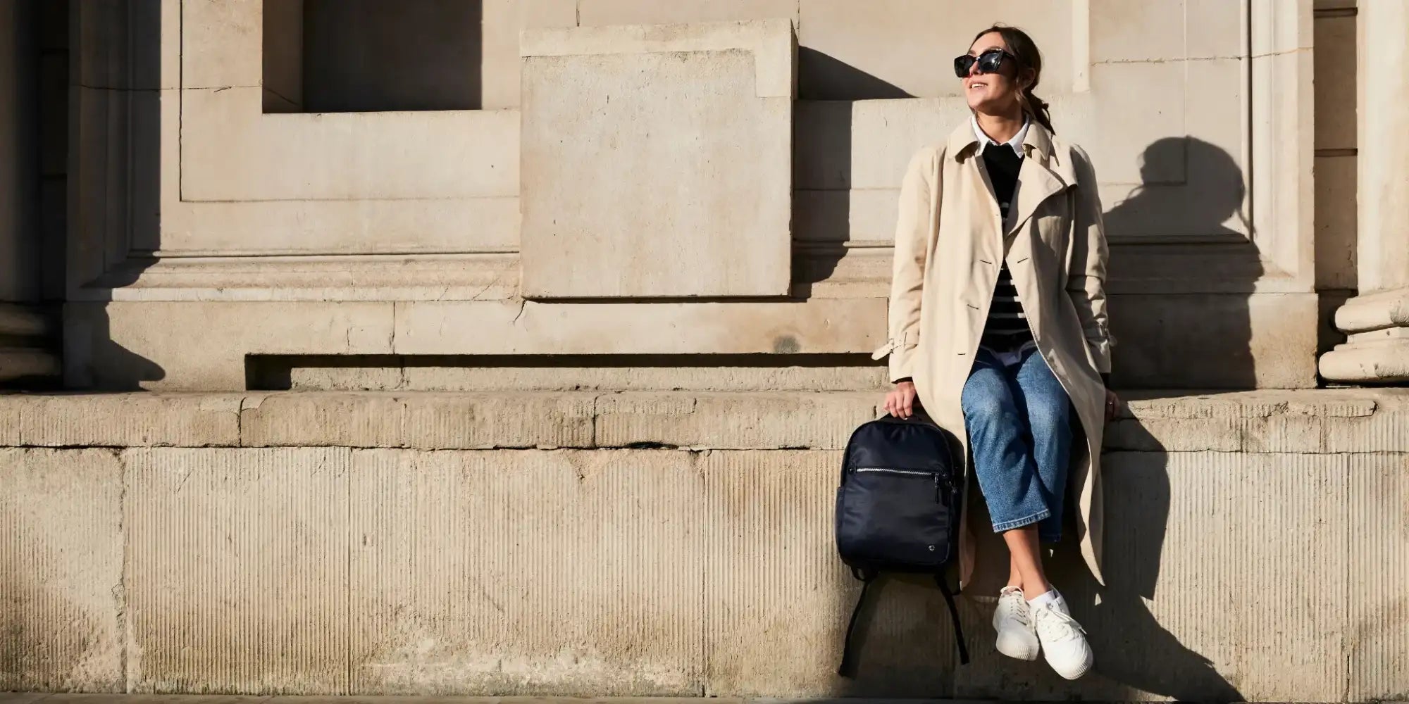 Navy blue backpack with black zippers and a minimalist design