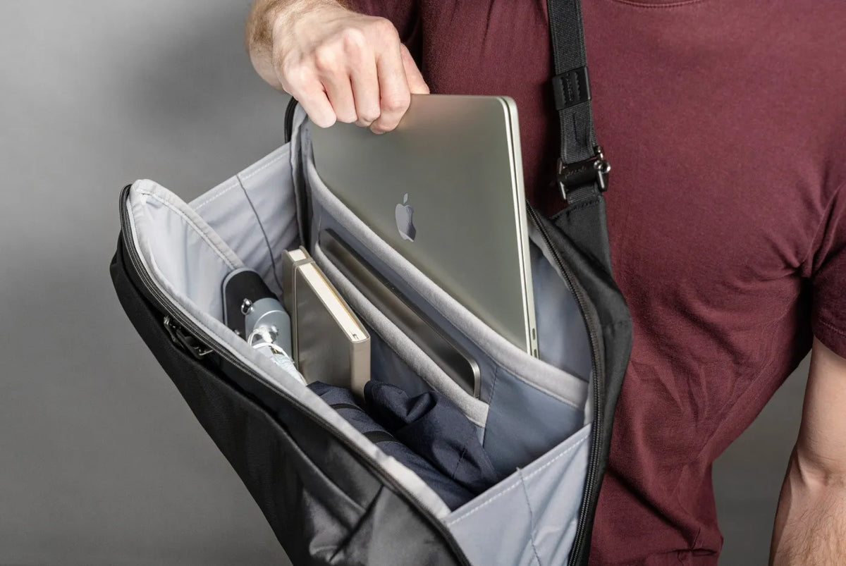Pacsafe Metrosafe X Commuter Anti-Theft 16" Laptop Backpack in Black, the main compartment open, holding a laptop, tablet and water bottle