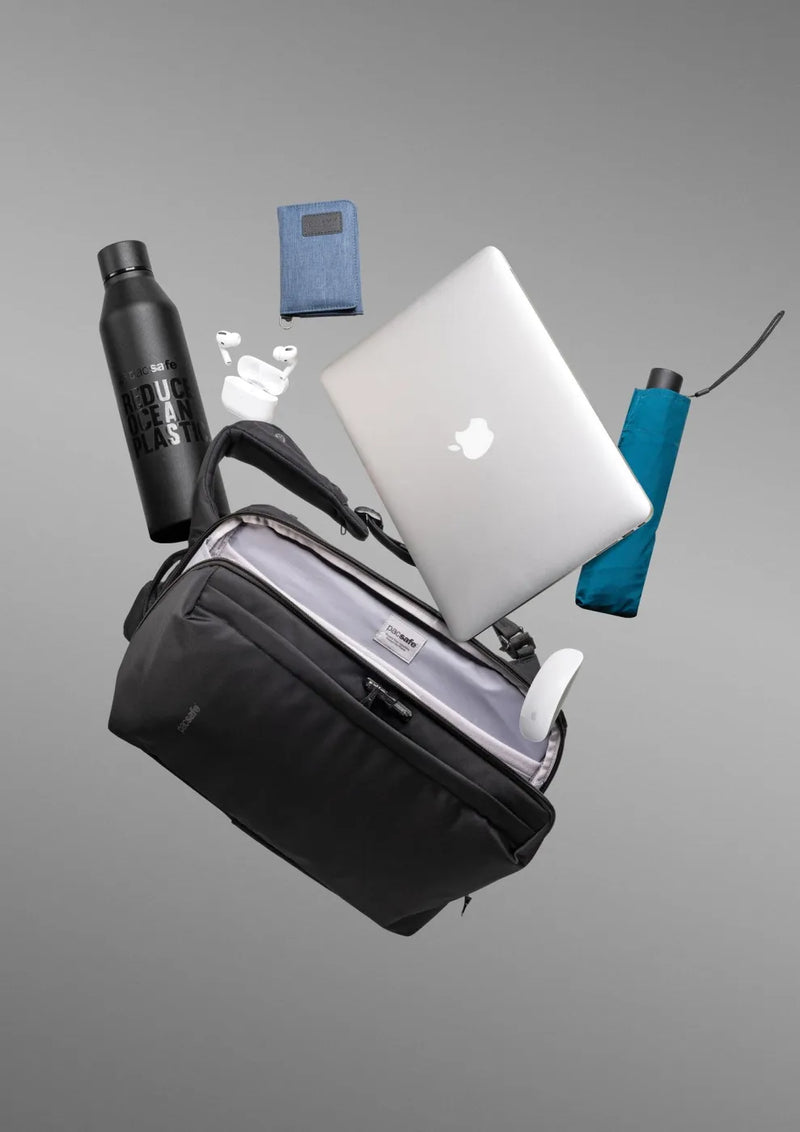 Pacsafe Metrosafe X Commuter Anti-Theft 16" Laptop Backpack in Black, shown with a laptop, water bottle, umbrella, notebook and earbuds it holds
