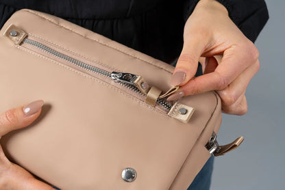 Pacsafe W Anti-theft 3-in-1 Sling Bag in Taupe, the zip pull being clipped back into its catch