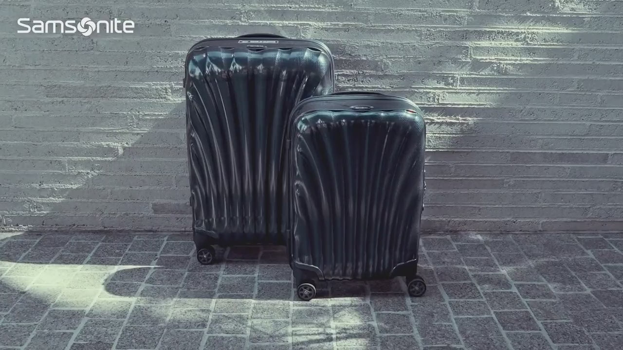 Samsonite C-Lite suitcases beside a classic convertible