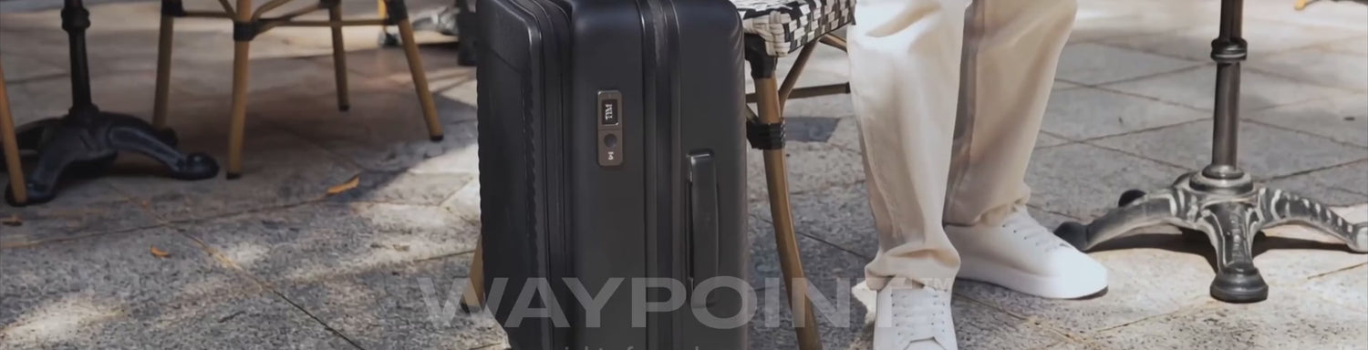 Samsonite Zipprix FT suitcase with the Waypoint smart tag, wheeled away from a cafe table