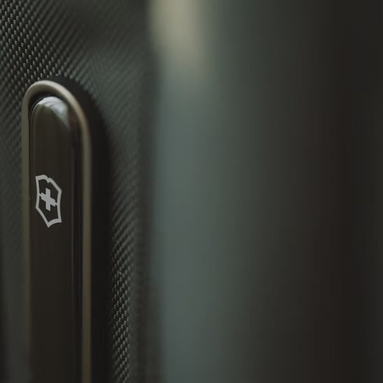 Victorinox Werks Traveler 7.0 boarding backpack in black carried by a traveller from a hotel room into a car, a train and a meeting room