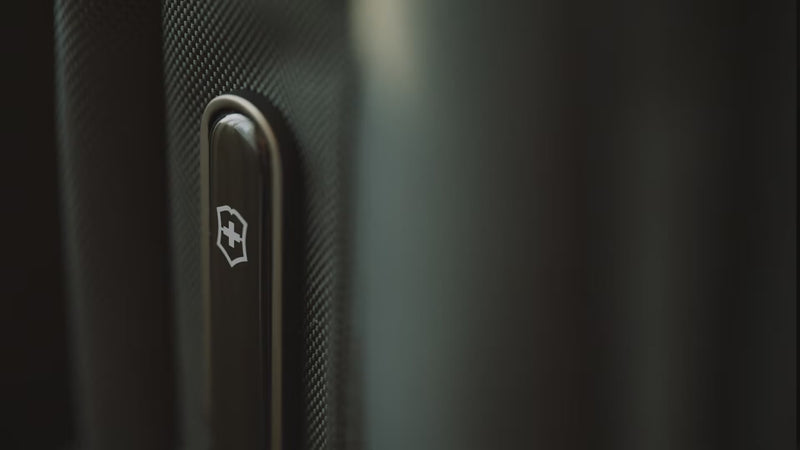 Victorinox Werks Traveler 7.0 boarding backpack in black carried by a traveller from a hotel room into a car, a train and a meeting room