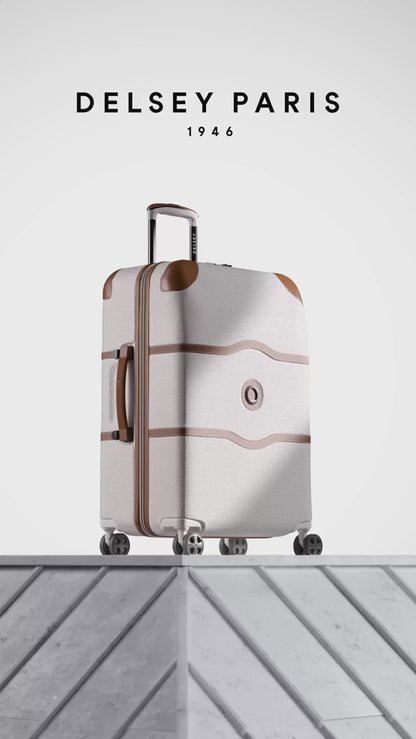 Delsey Chatelet Air 2.0 suitcase in angora white with tan trim: dual-density wheels, the double-layer zip teeth and lock, the red patterned deluxe lining, then the case on a stone plinth