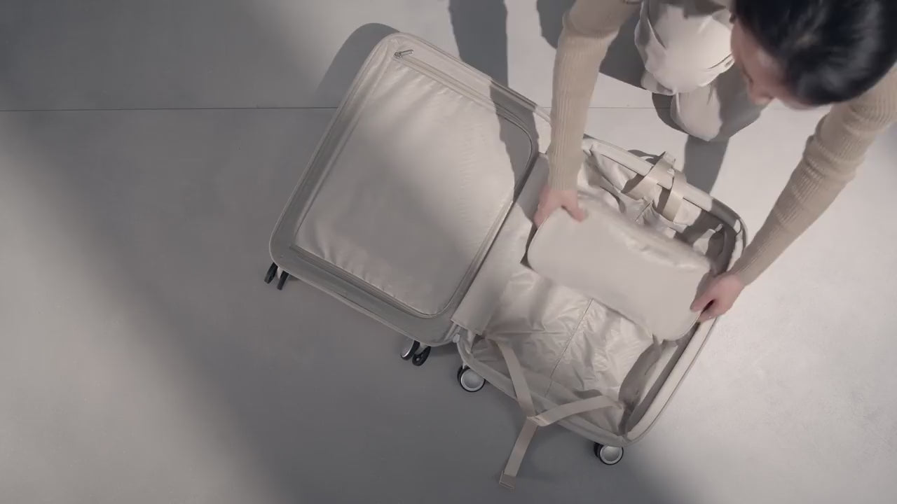 Samsonite Paralux carry-on being packed and wheeled away
