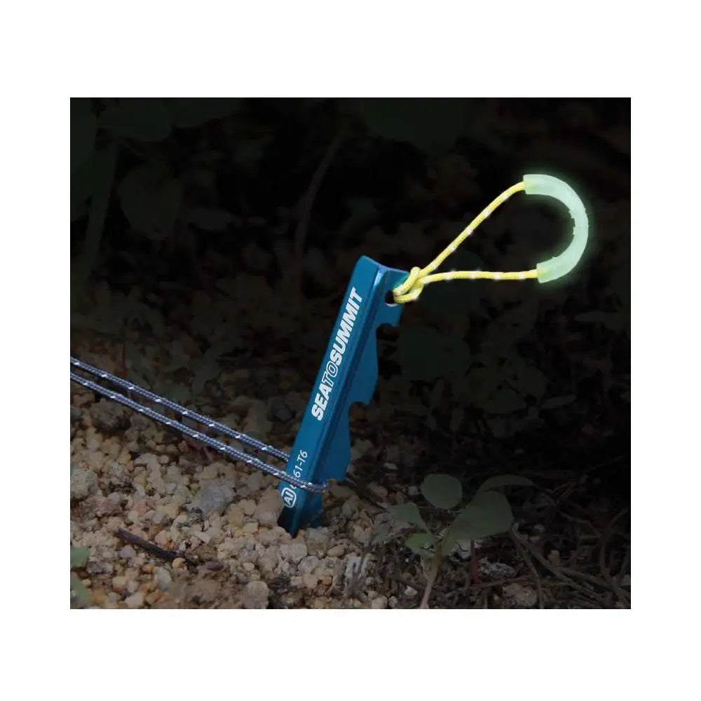 Luminescent pull loop for peg extraction; charges in sunlight, emits green glow at night