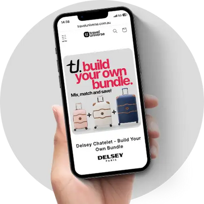 A sleek black smartphone displaying a travel universe website ad for the delsey chatelot suitcase bundle.