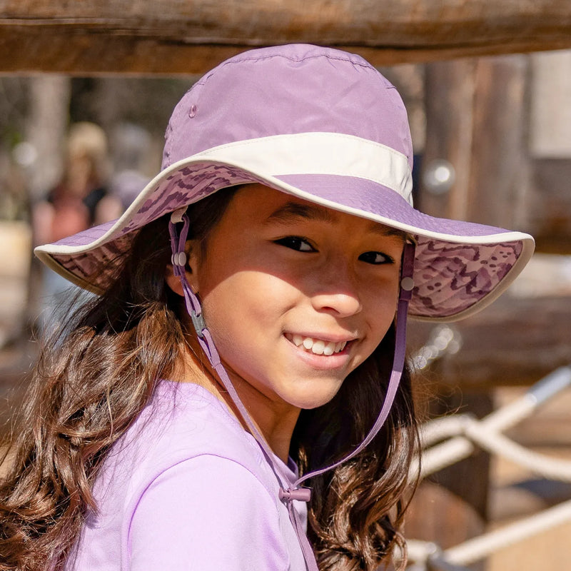 A child wearing a Sunday Afternoons Kids Clear Creek Boonie Hat