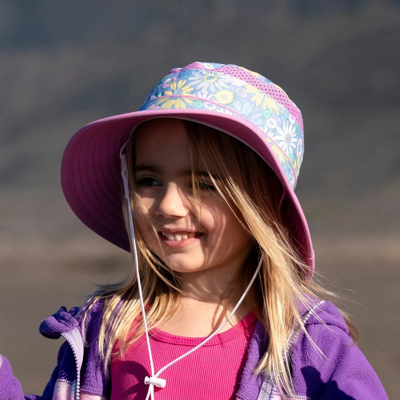 A child wearing a Sunday Afternoons Kids Fun Bucket Hat