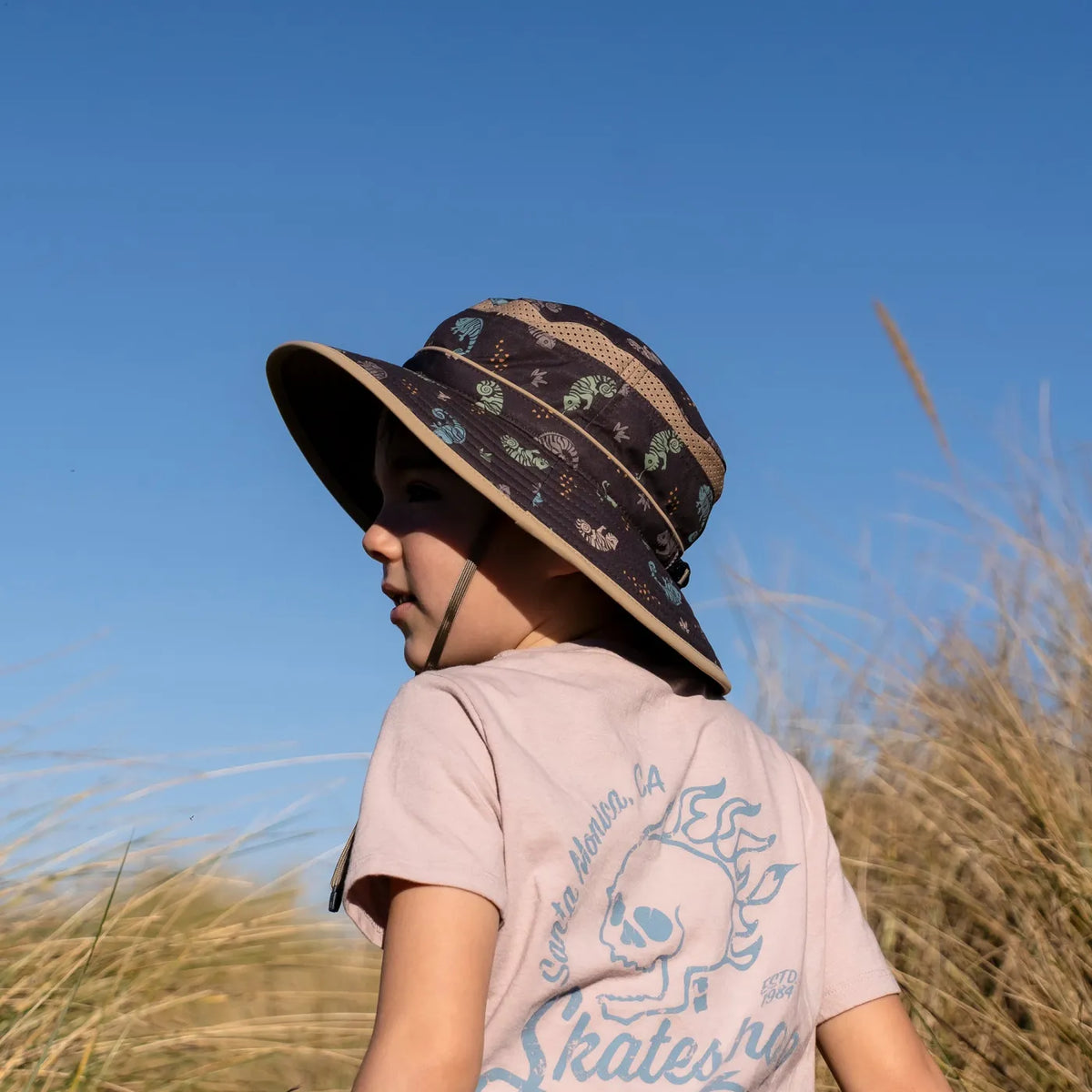 A child wearing a Sunday Afternoons Kids Fun Bucket Hat