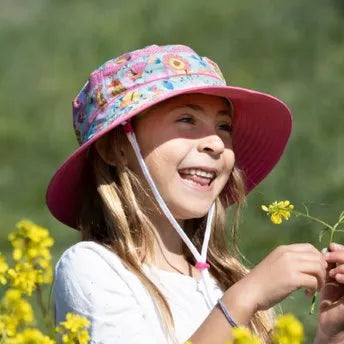 A child wearing a Sunday Afternoons Kids Fun Bucket Hat