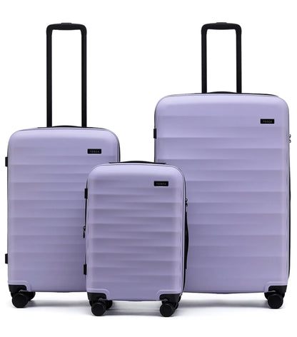 Set of three lavender tosco interstellar 2.0 hard-shell suitcases in three sizes with black handles and wheels