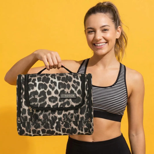 girl holding a Tosca So Lite Hanging Vanity Bag - Leopard