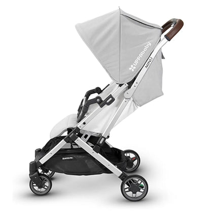 Pivots down to remain attached while folding with stroller