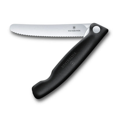 Victorinox Swiss Classic foldable paring knife in black, opened flat with the 11 cm serrated blade extended, seen from above