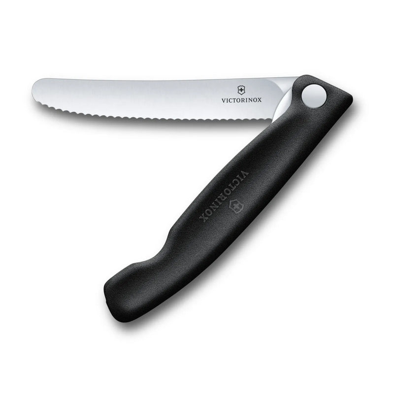 Victorinox Swiss Classic foldable paring knife in black, opened flat with the 11 cm serrated blade extended, seen from above